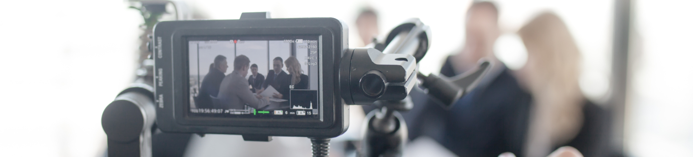 Videographer recording a deposition