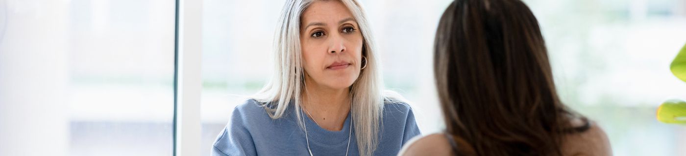 businesswoman listens to female client