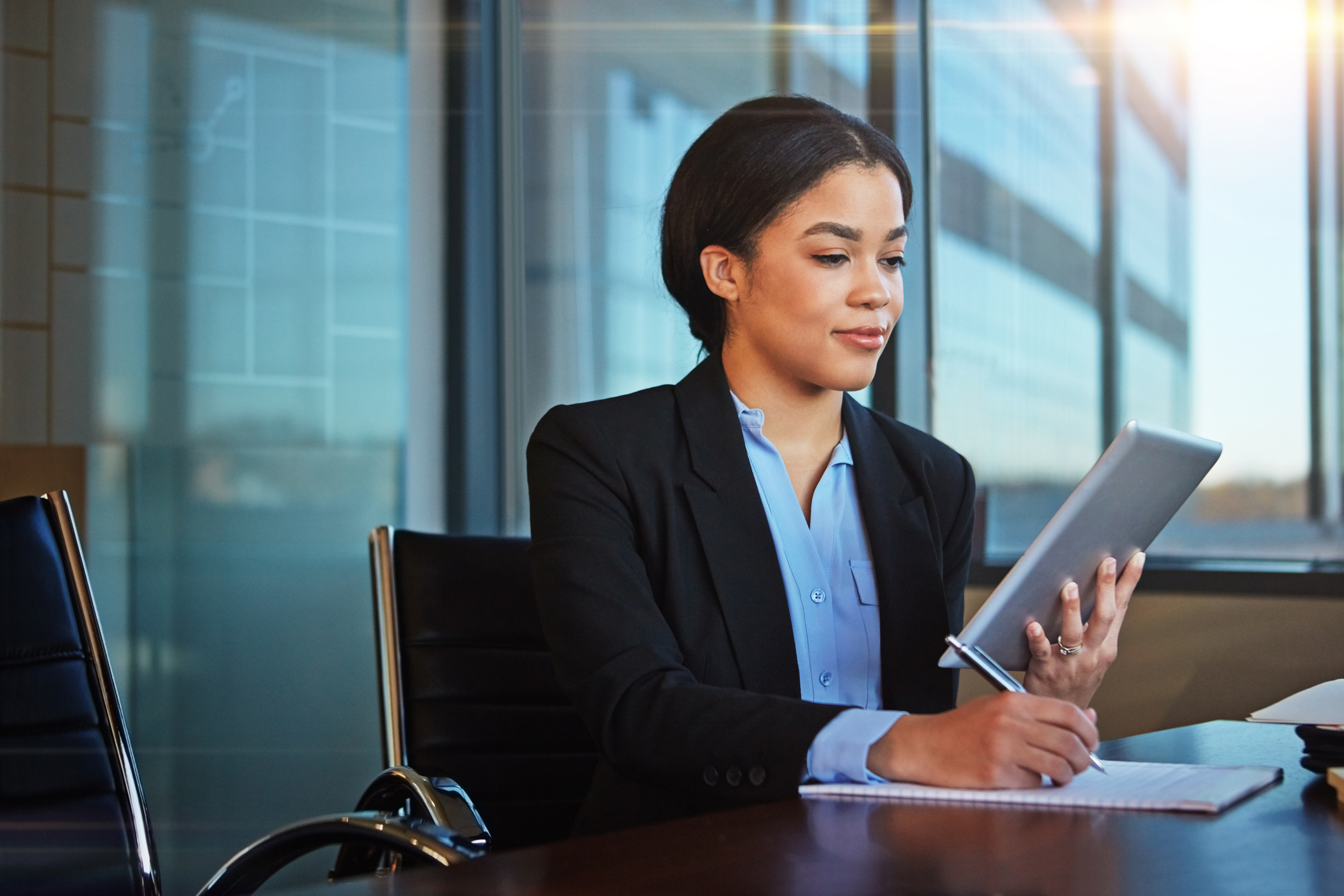 shot of a businesswoman taking notes while using her tablet