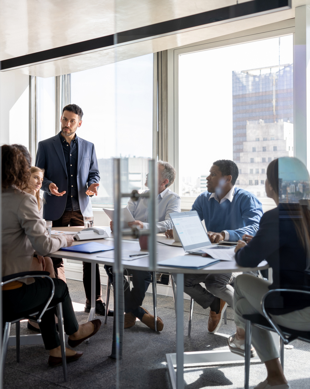 business man talking to a group of people in a meeting at the office