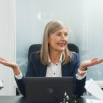 Lawyers discussing documents around a conference table in an office